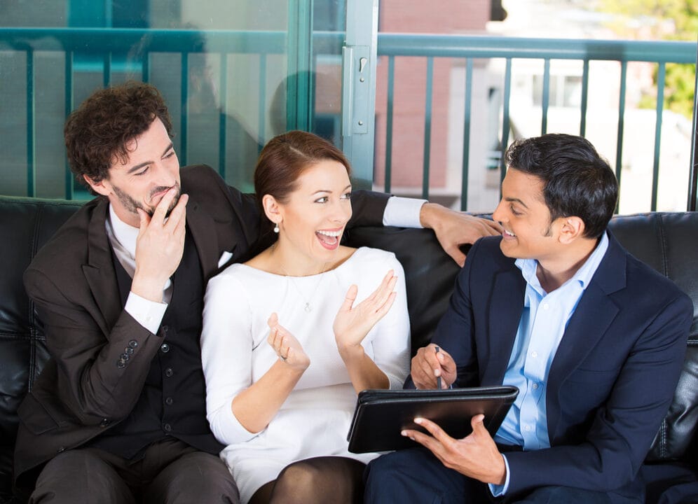 Legal team discussing with SpineLegal Software on a tablet, enhancing efficiency and collaboration in law practice.